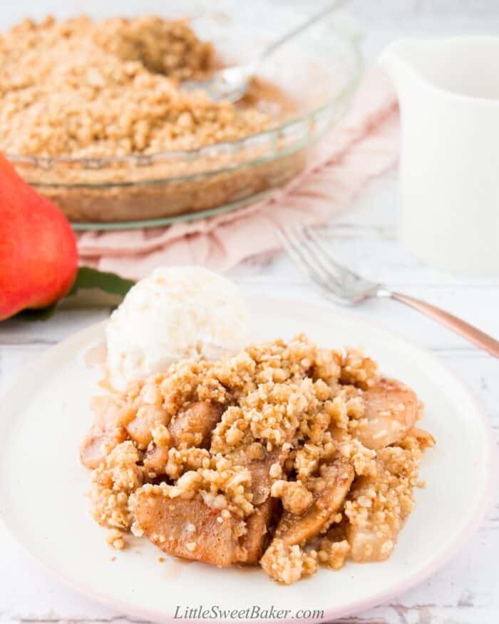 A serving of pear crisp with ice cream.