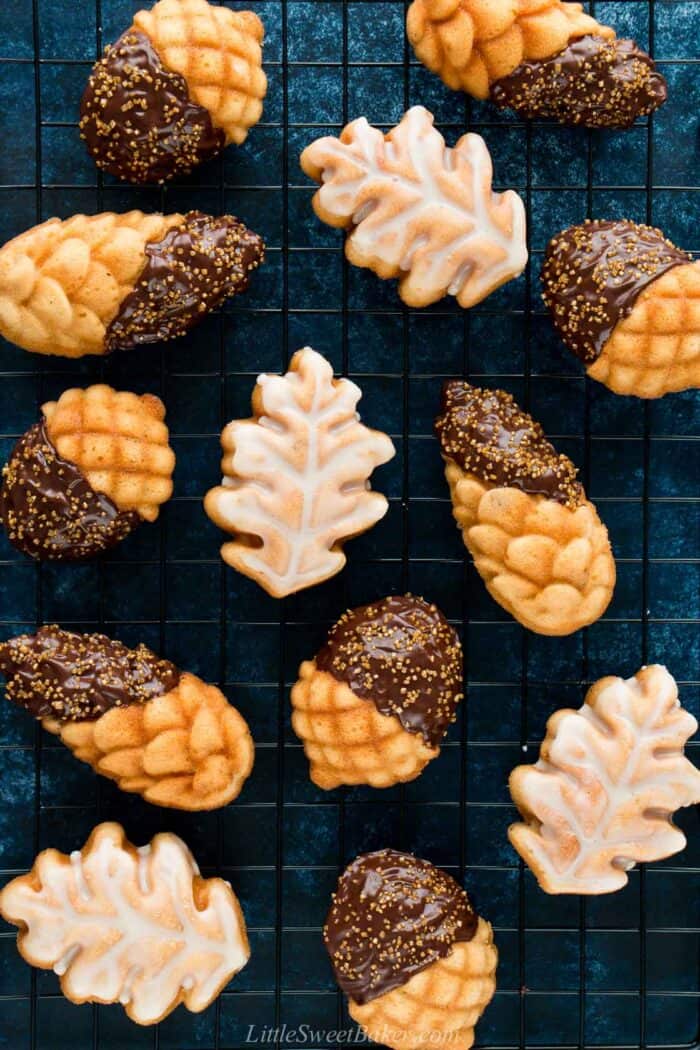 Maple pecan cakelets covered in chocolate and glaze on a cooling rack.