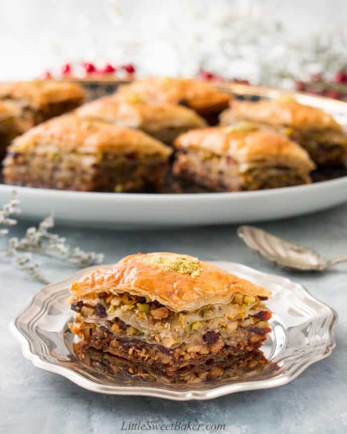 A slice of cranberry pistachio baklava on a silver plate.