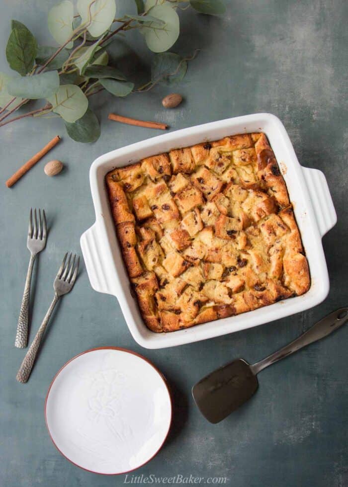 A square casserole dish of eggnog bread pudding.