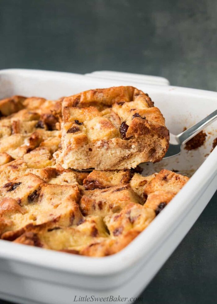A slice of eggnog bread pudding being lifted.