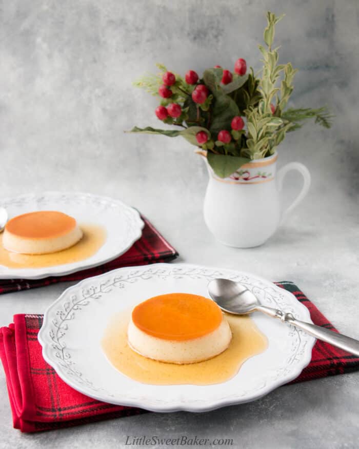 Creme caramel on a light gray plate with spoon and red plaid napkin.