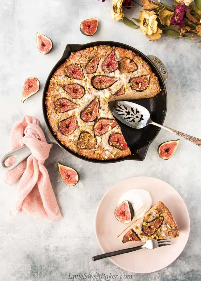 Fig skillet cake with a slice on a plate.