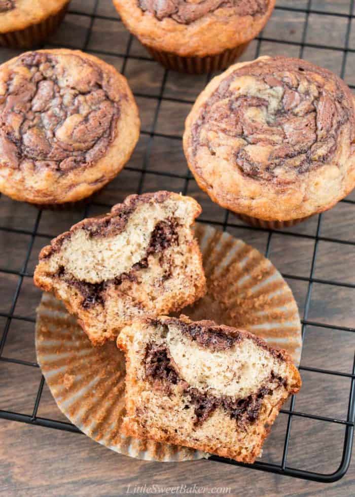 A Nutella banana muffin cut in half on a cooling rack.