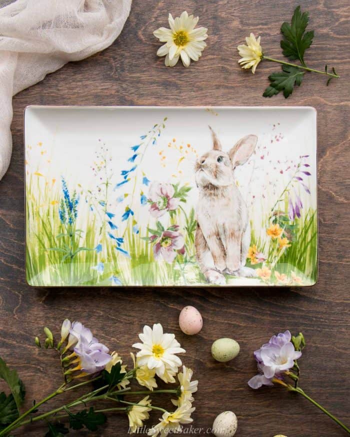 An Easter platter from Williams Sonoma with flowers and Easter eggs around it.