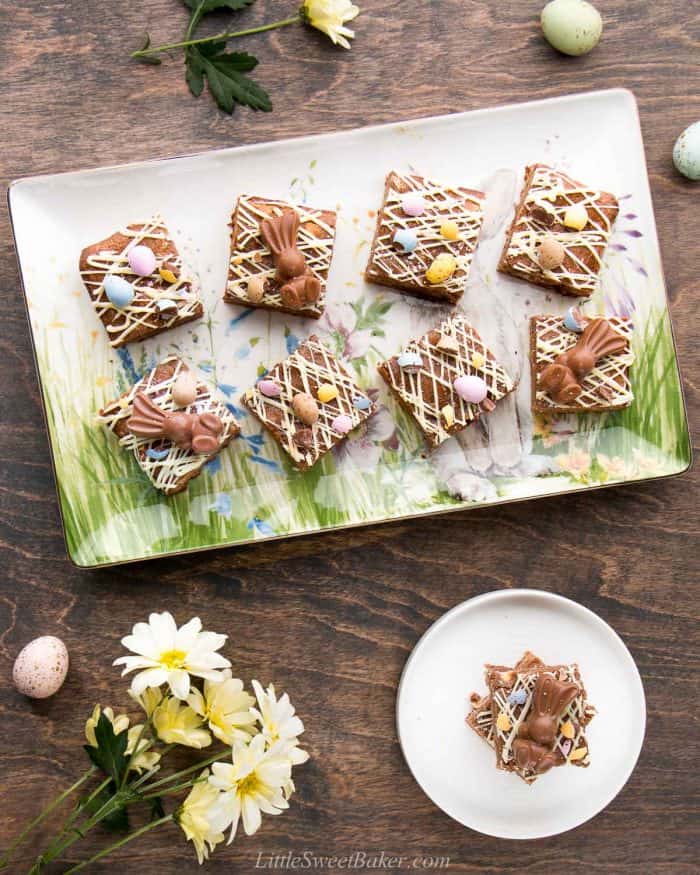 Easter blondies on an Easter platter with flours and speckled egg around.