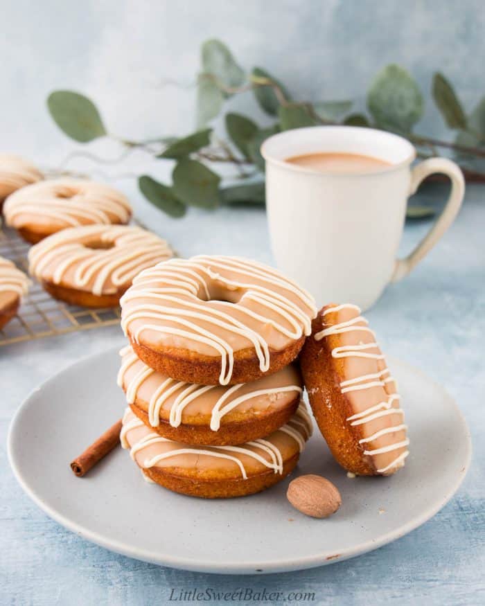 Four sweet potato donuts on a light blue plate.