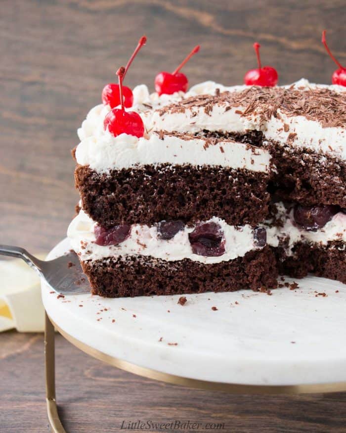 A slice of naked black forest cake being removed from the rest of the cake.