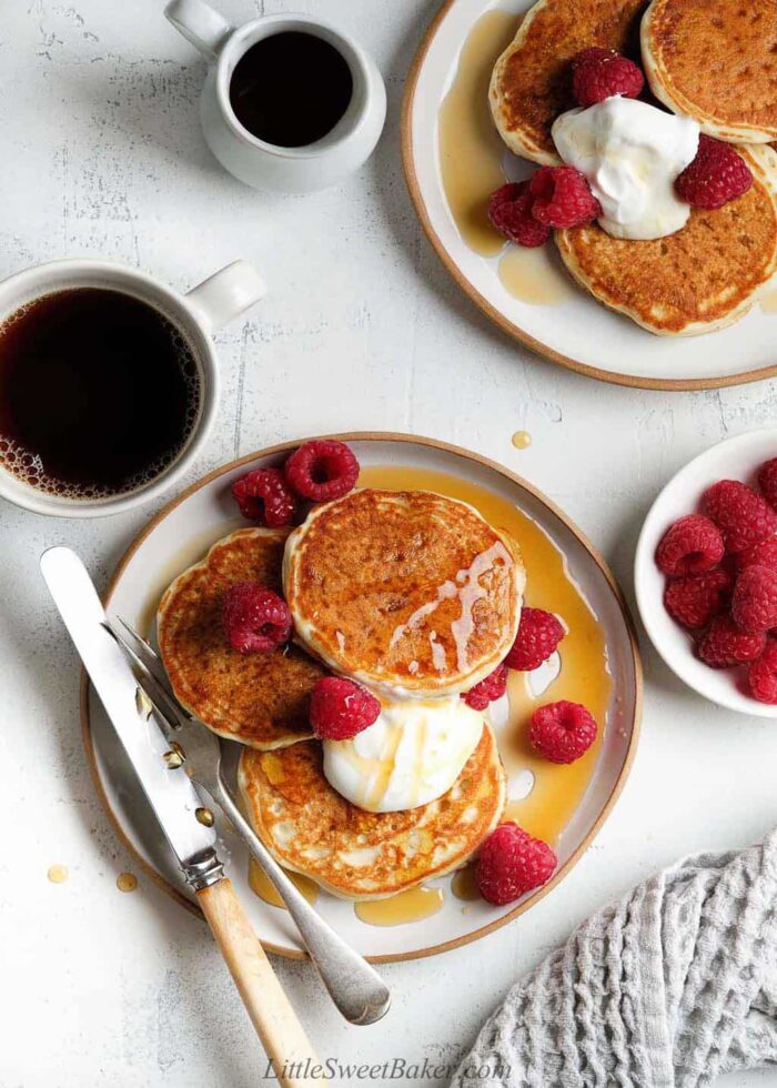 A breakfast table of pancakes and coffee.