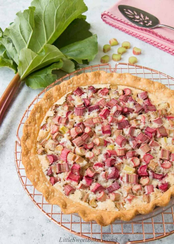 A rhubarb custard pie on a copper cooling rack.