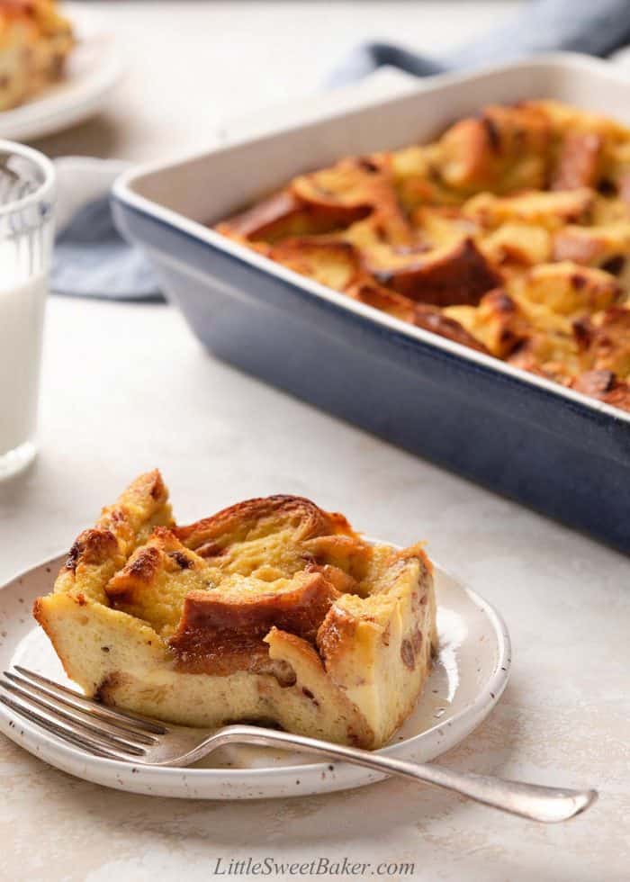 A slice of old-fashioned bread pudding on a plate with a fork.