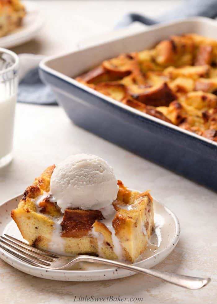 A slice of bread pudding with a scoop of vanilla ice cream on top.