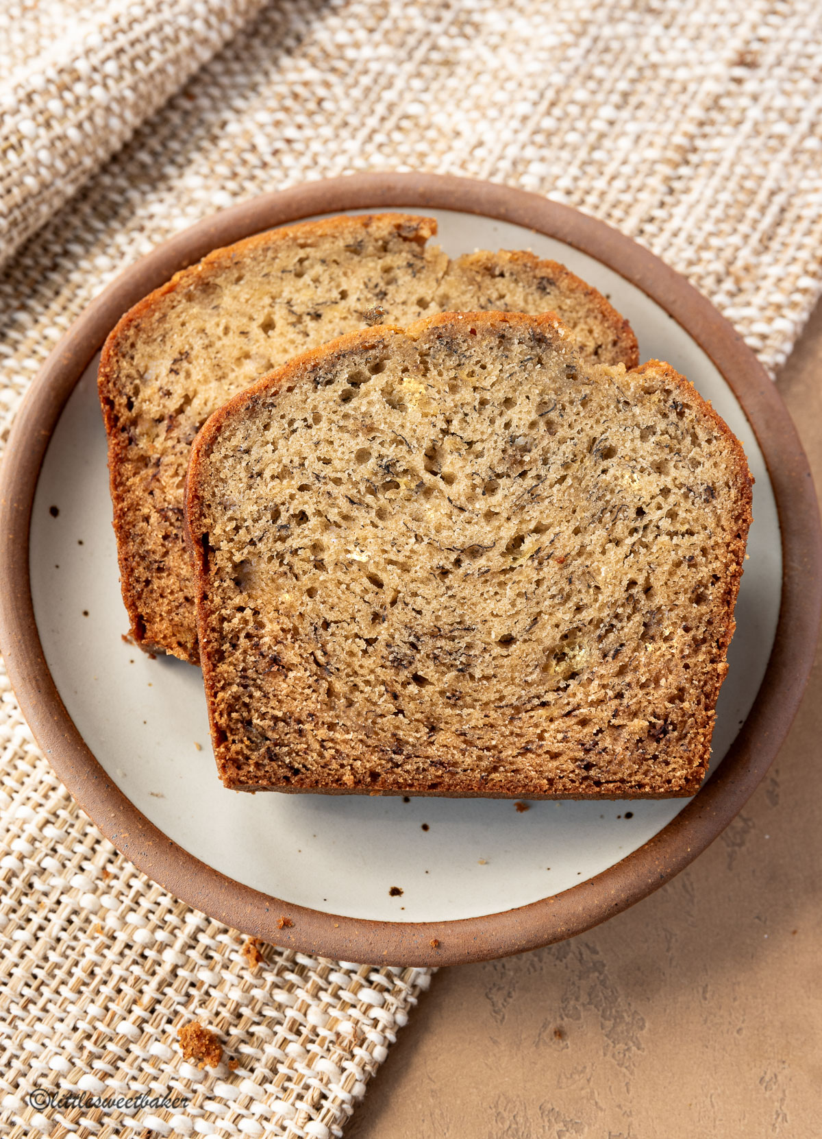 Two slices of banana bread on a plate.