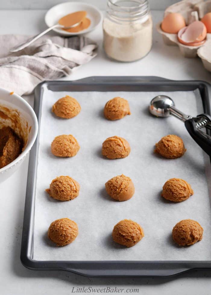 Unbaked healthy peanut butter cookies on a baking tray.