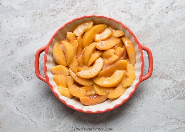 peach filling in a round orange ceramic dish