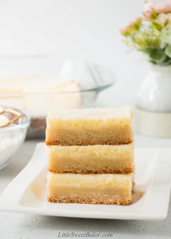 A stack of ooey gooey butter cake on a white plate.