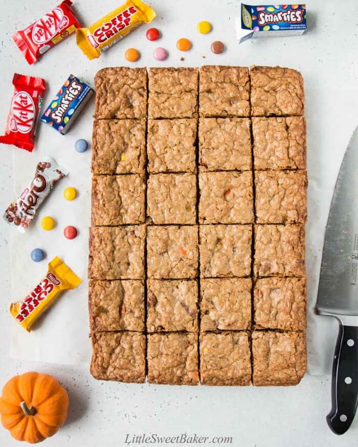 Oatmeal cookie bars cut into 24 squares with Halloween chocolates
