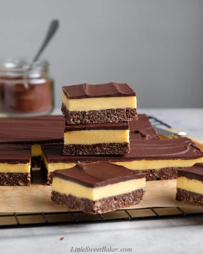 A slab of Nanaimo bars with two stacked on top.