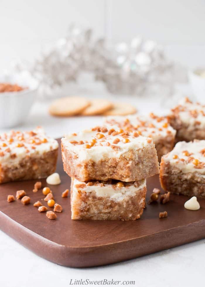 Skor bars with Ritz crackers on a wooden cutting board.