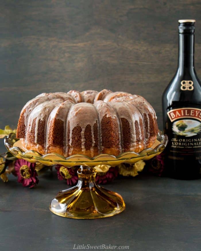 An Irish cream bundt cake on a vintage glass cake stand.