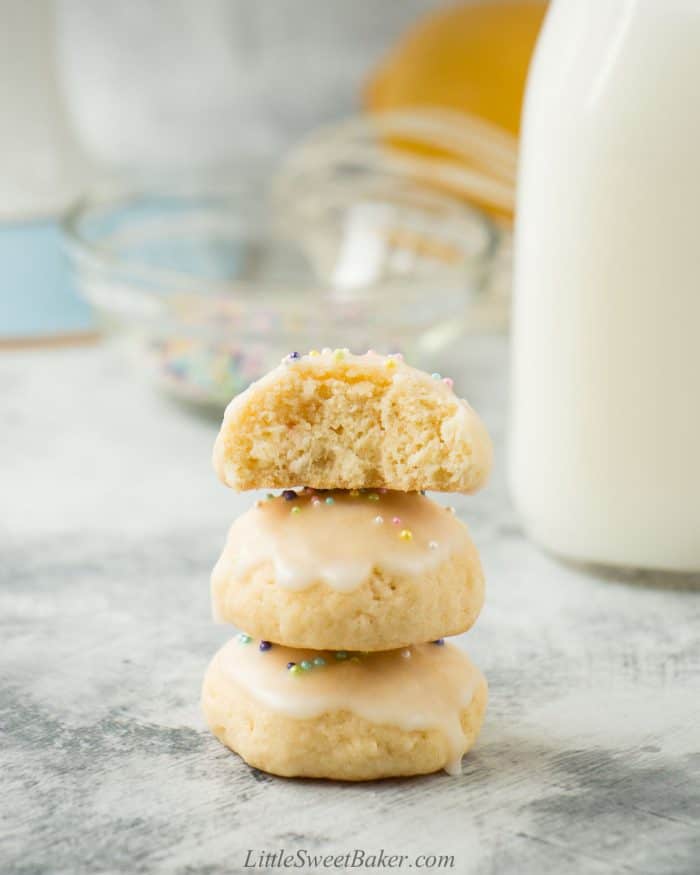 A triple stack of Italian Easter cookies with a bite taken out of the top one.