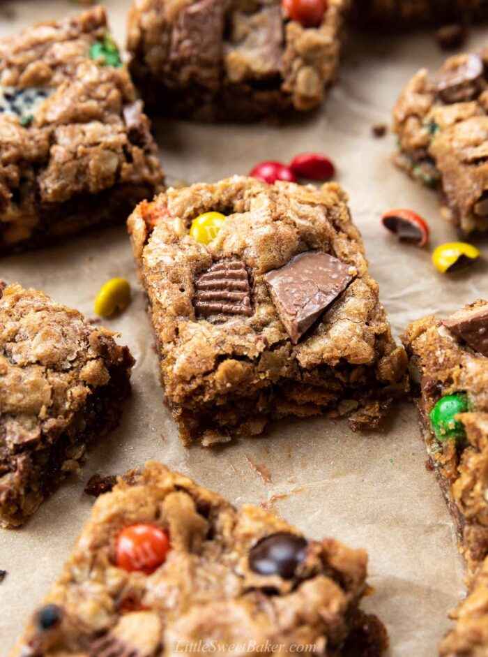 close up of a candy cookie bars on brown parchment paper