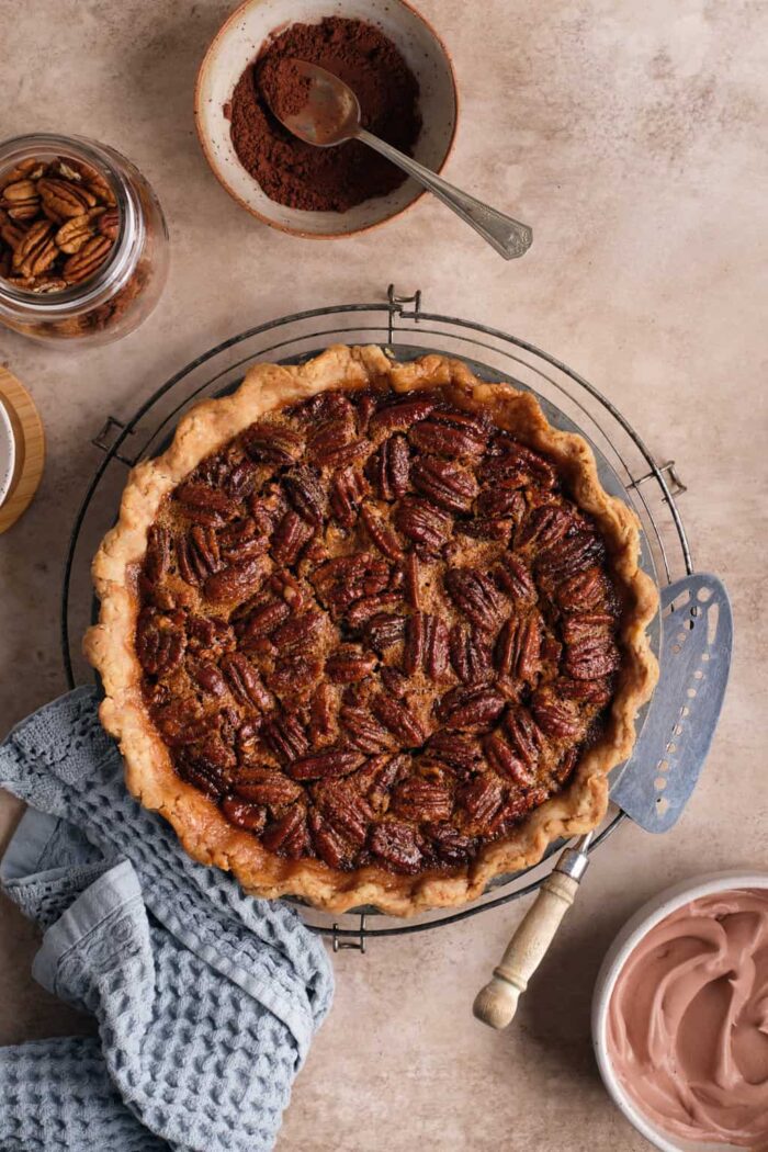 A whole pecan pie on a cooling rack 