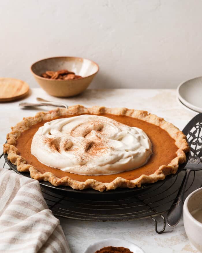 Pumpkin pie topped with caramel whipped cream and cinnamon