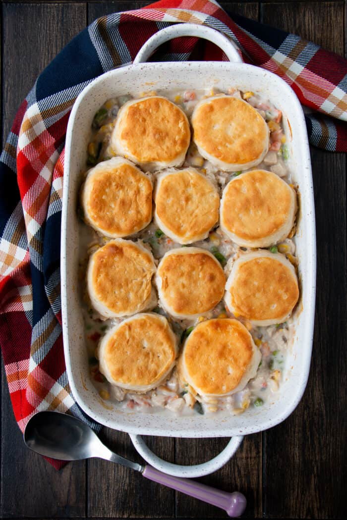 Turkey and biscuit casserole in a white casserole dish.