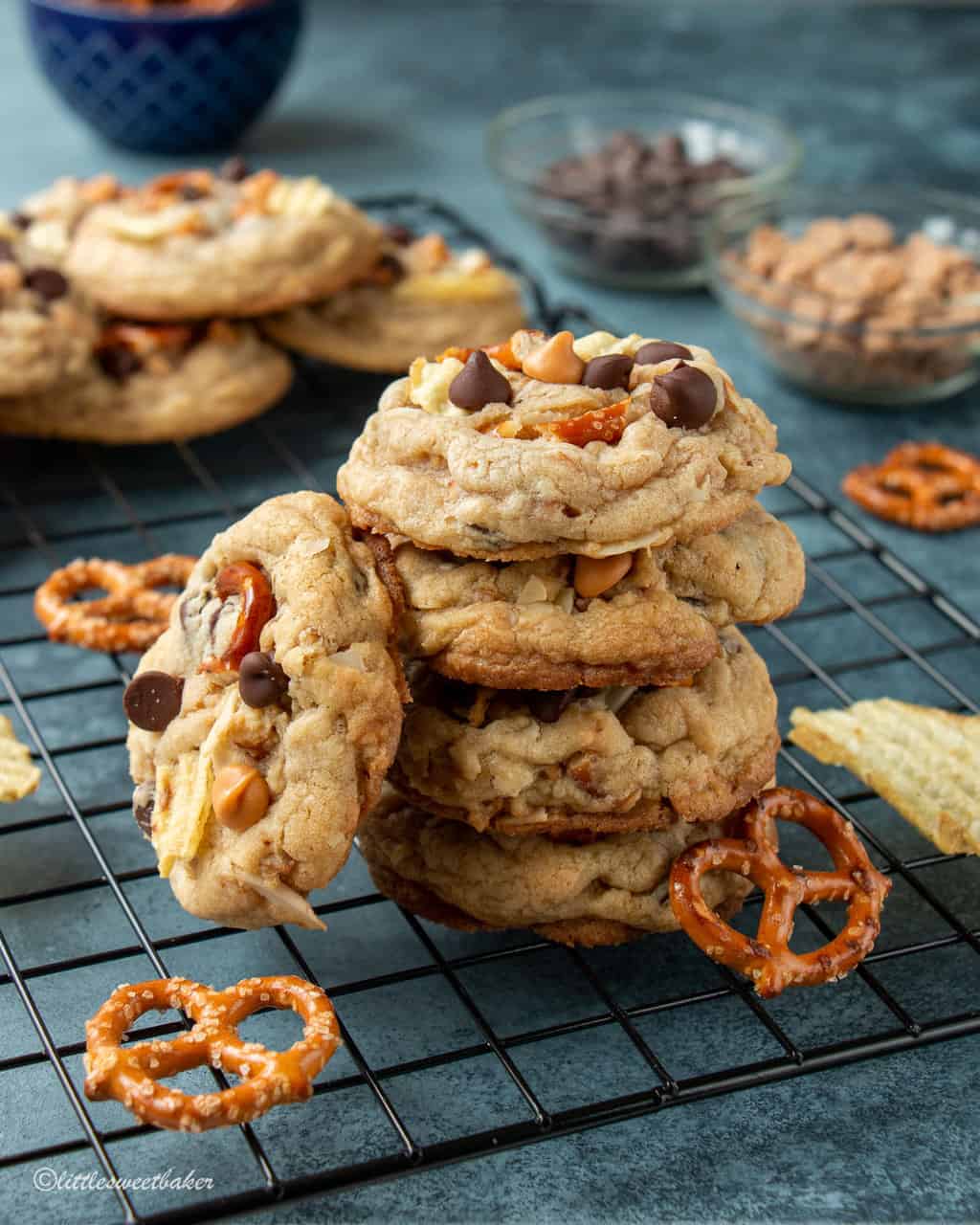 A stack of kitchen sink cookies on a cooling rack