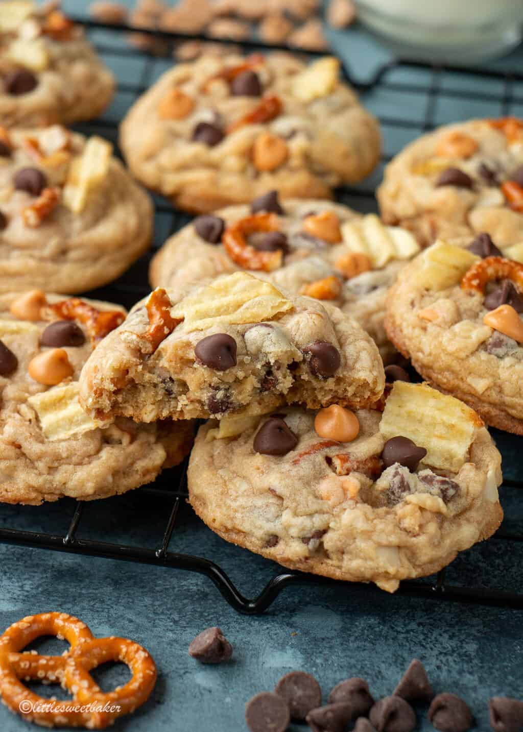 kitchen sink cookies on a cooling rack with one broken in half