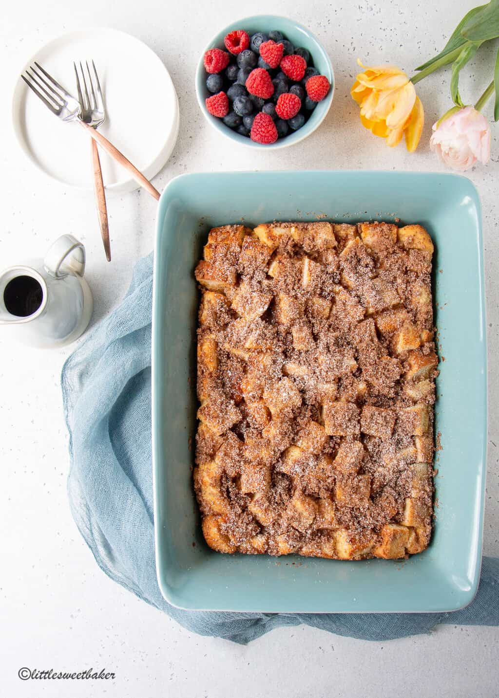A whole french toast casserole on a light blue baking dish.