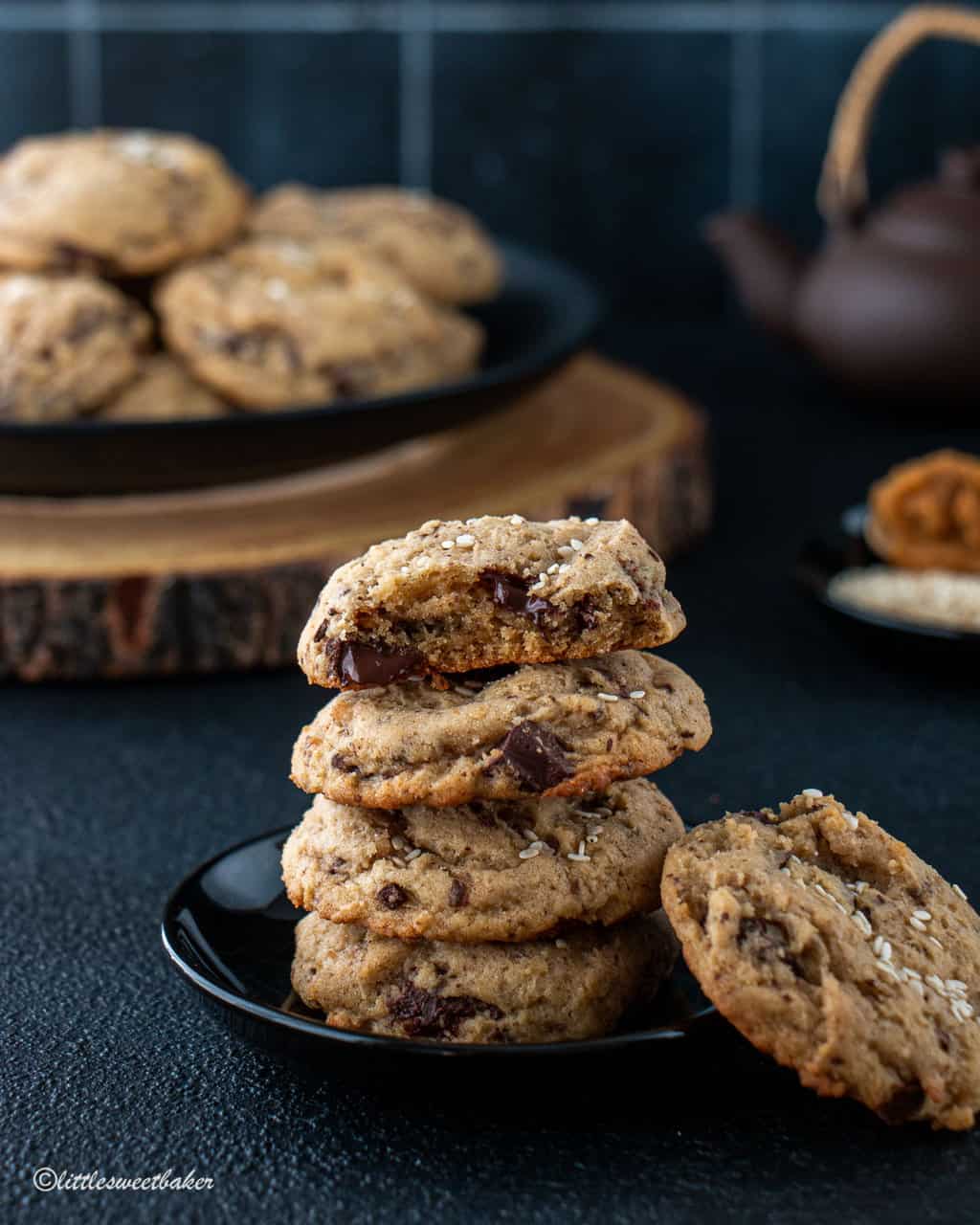 A stack of miso chocolate chip cookies on a mini black plate.