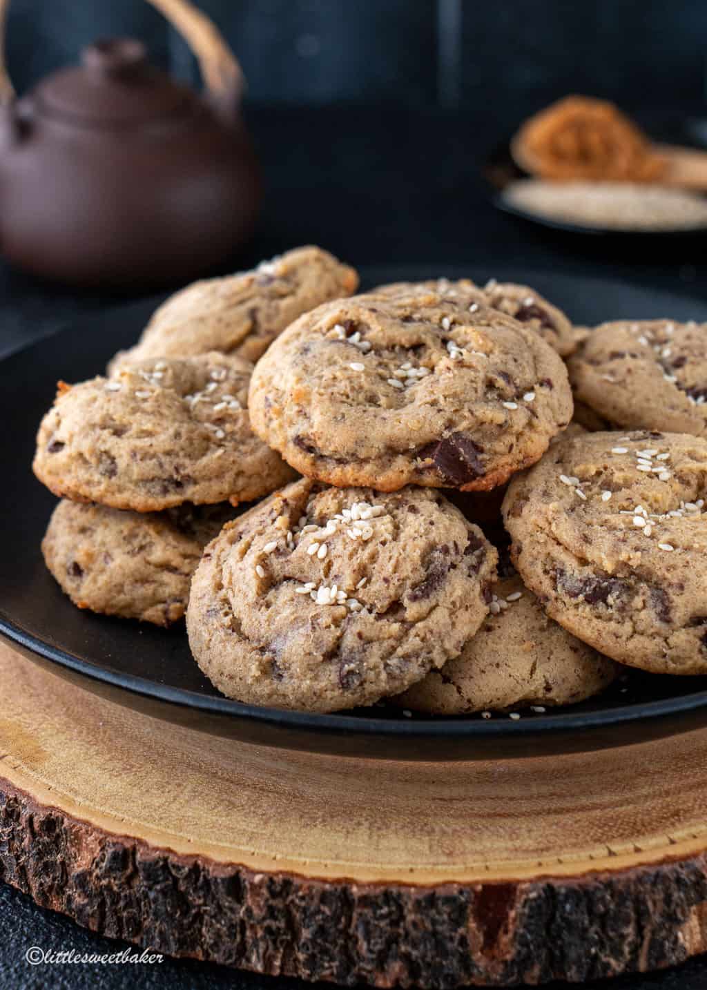 A plate of miso chocolate chip cookies on a wooden board.