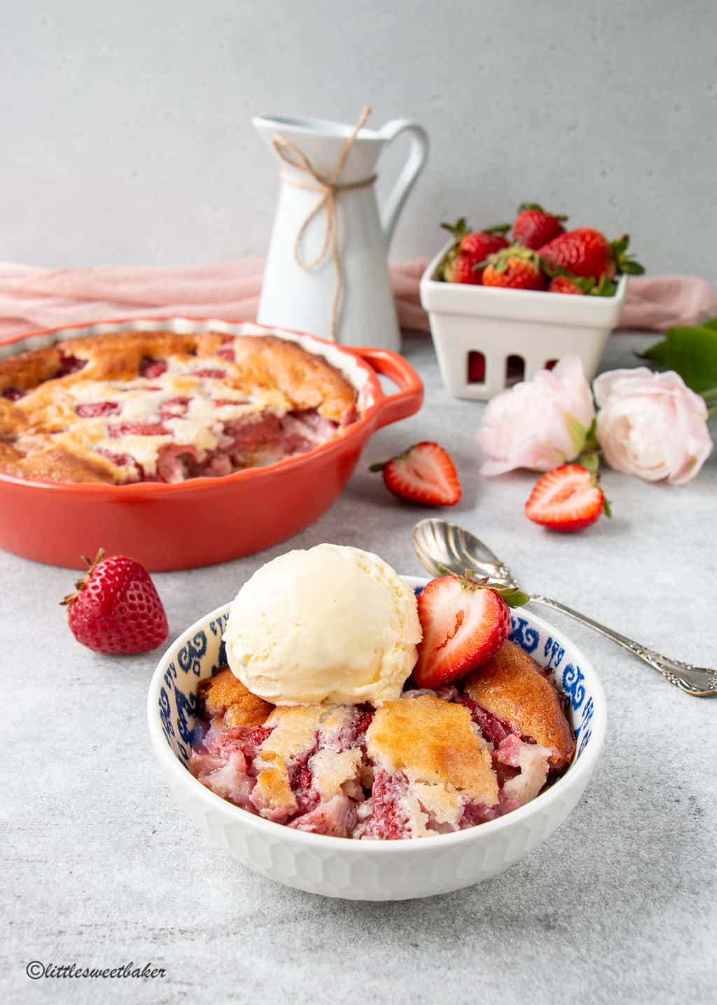 A bowl of strawberry cobbler with ice cream