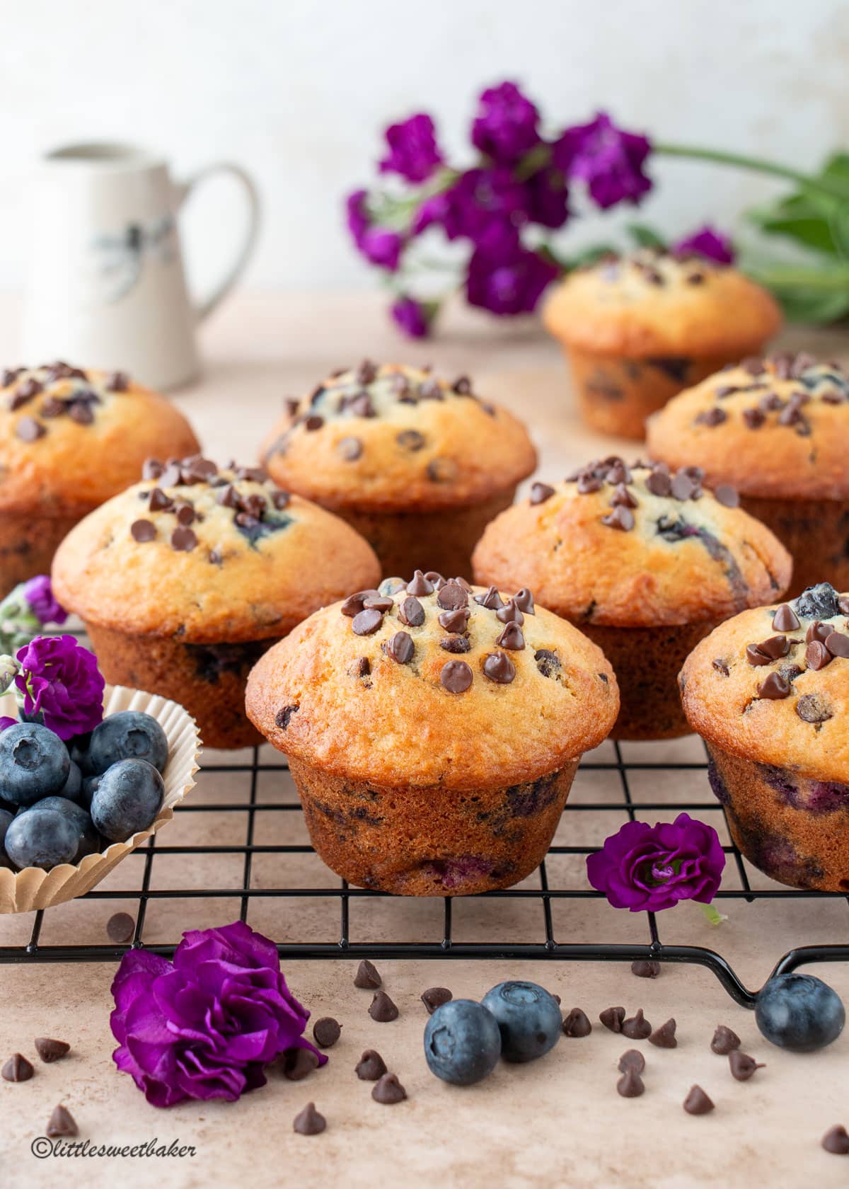 Blueberry chocolate chip muffins on a cooling rack.