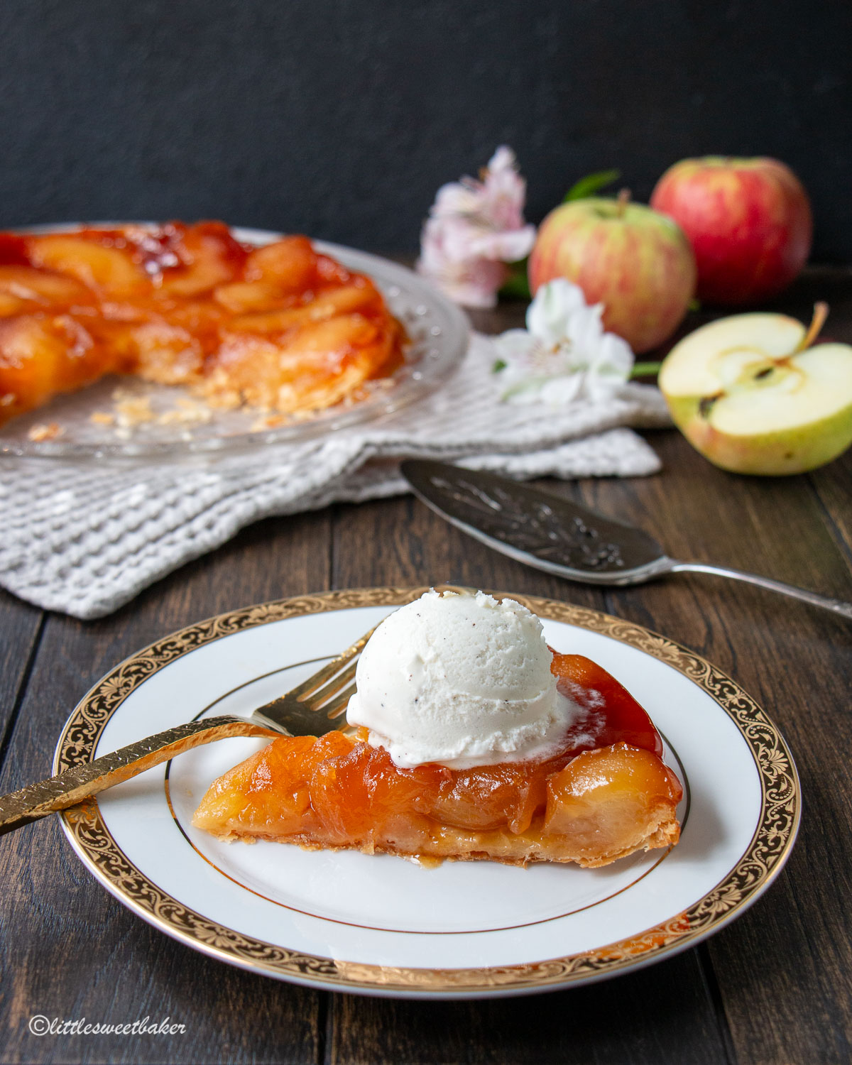 A slice of apple tarte tatin with vanilla ice cream.