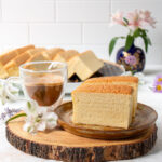 two pieces of Taiwanese castella cake on a plate and a cup of coffee