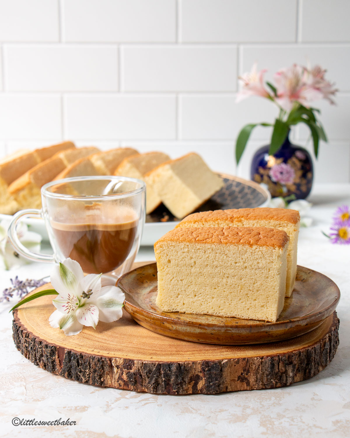 two pieces of Taiwanese castella cake on a plate and a cup of coffee