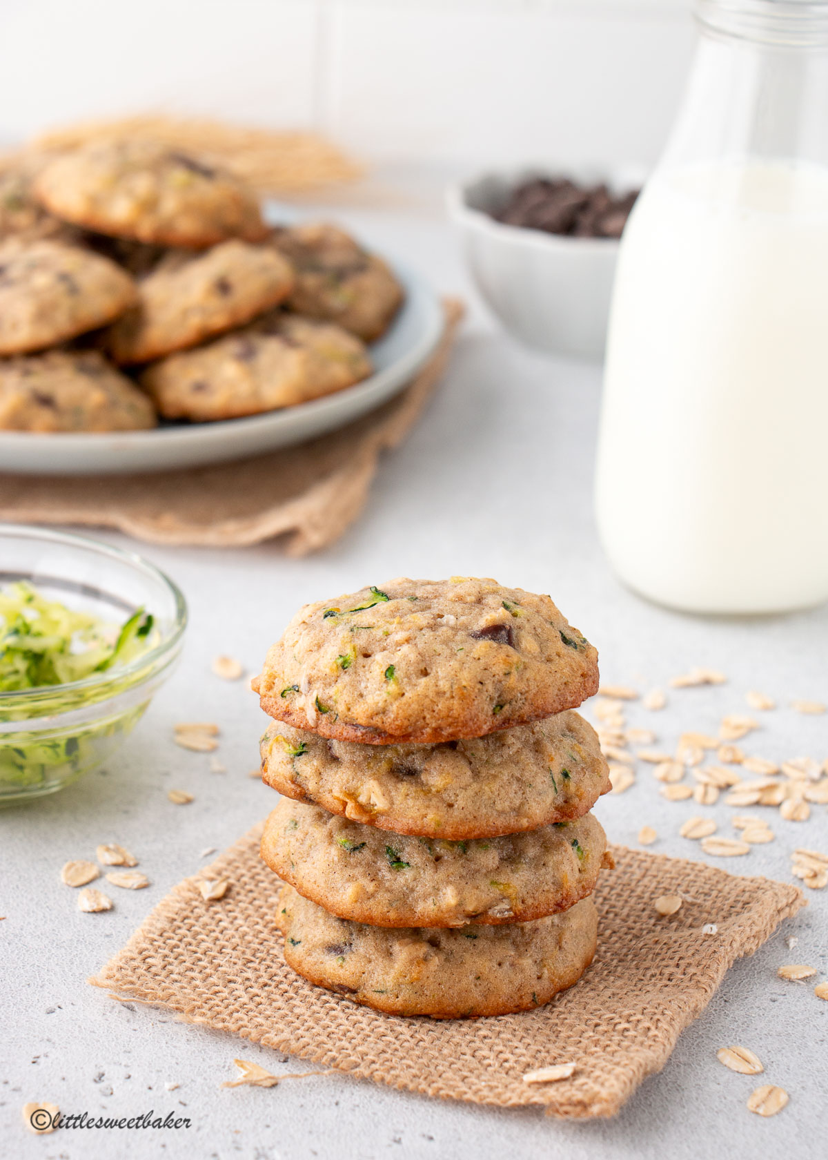 A stack of zucchini oatmeal cookies on a piece of burlap.