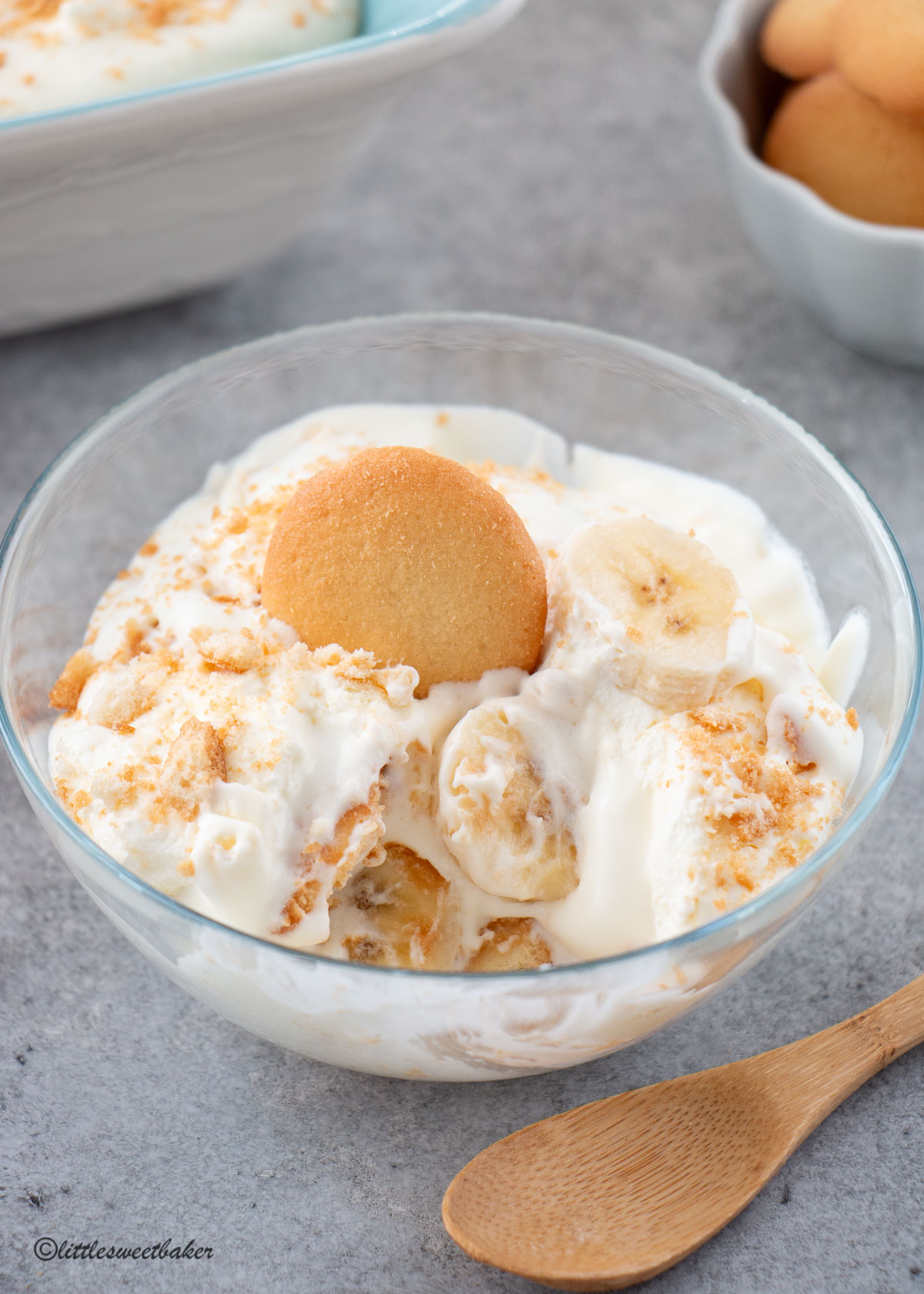 A bowl of banana pudding with a wooden spoon