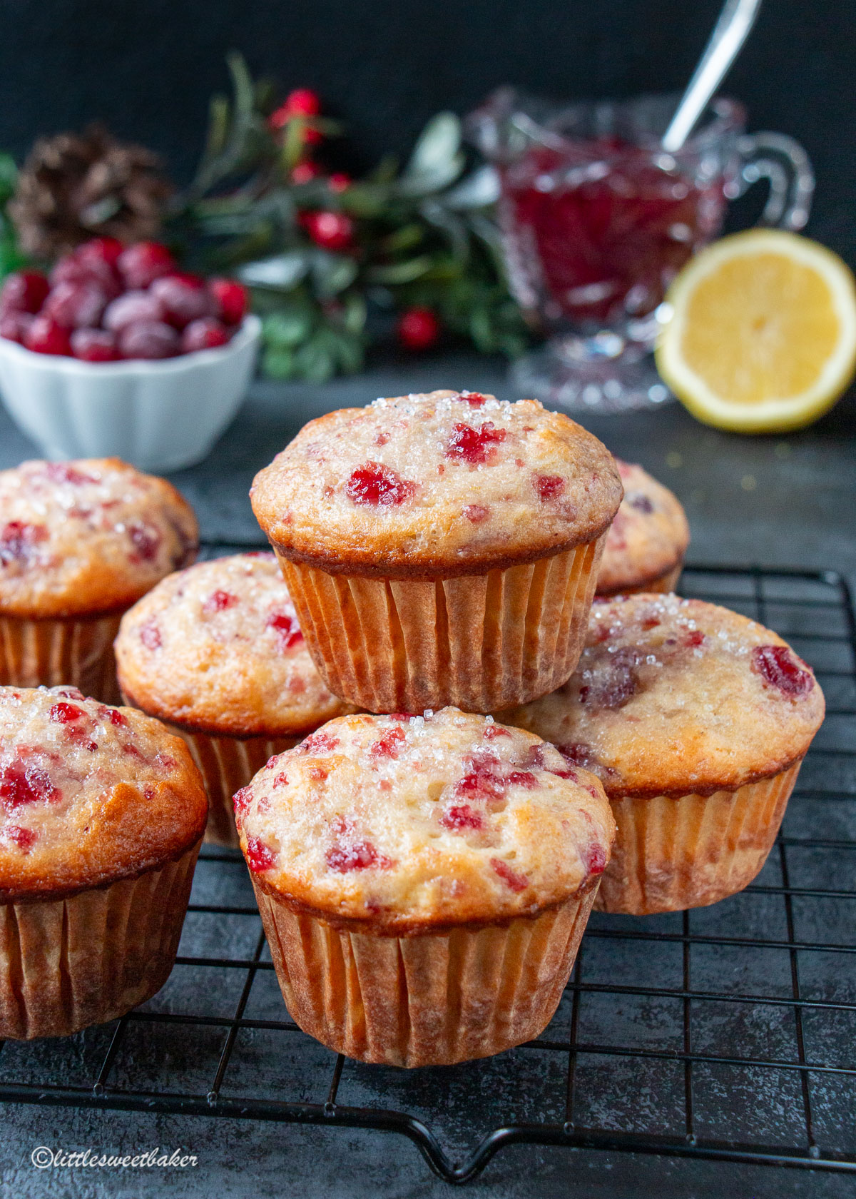 leftover cranberry sauce muffins stacked on a cooling rack