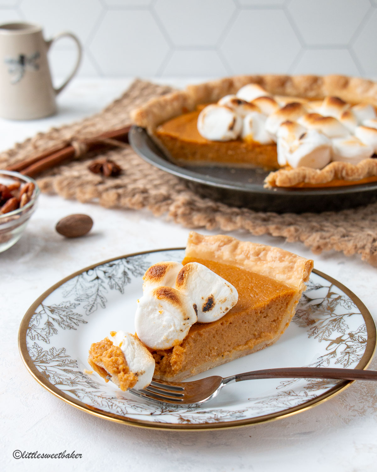 A slice of sweet potato pie on a plate with a piece on a fork.