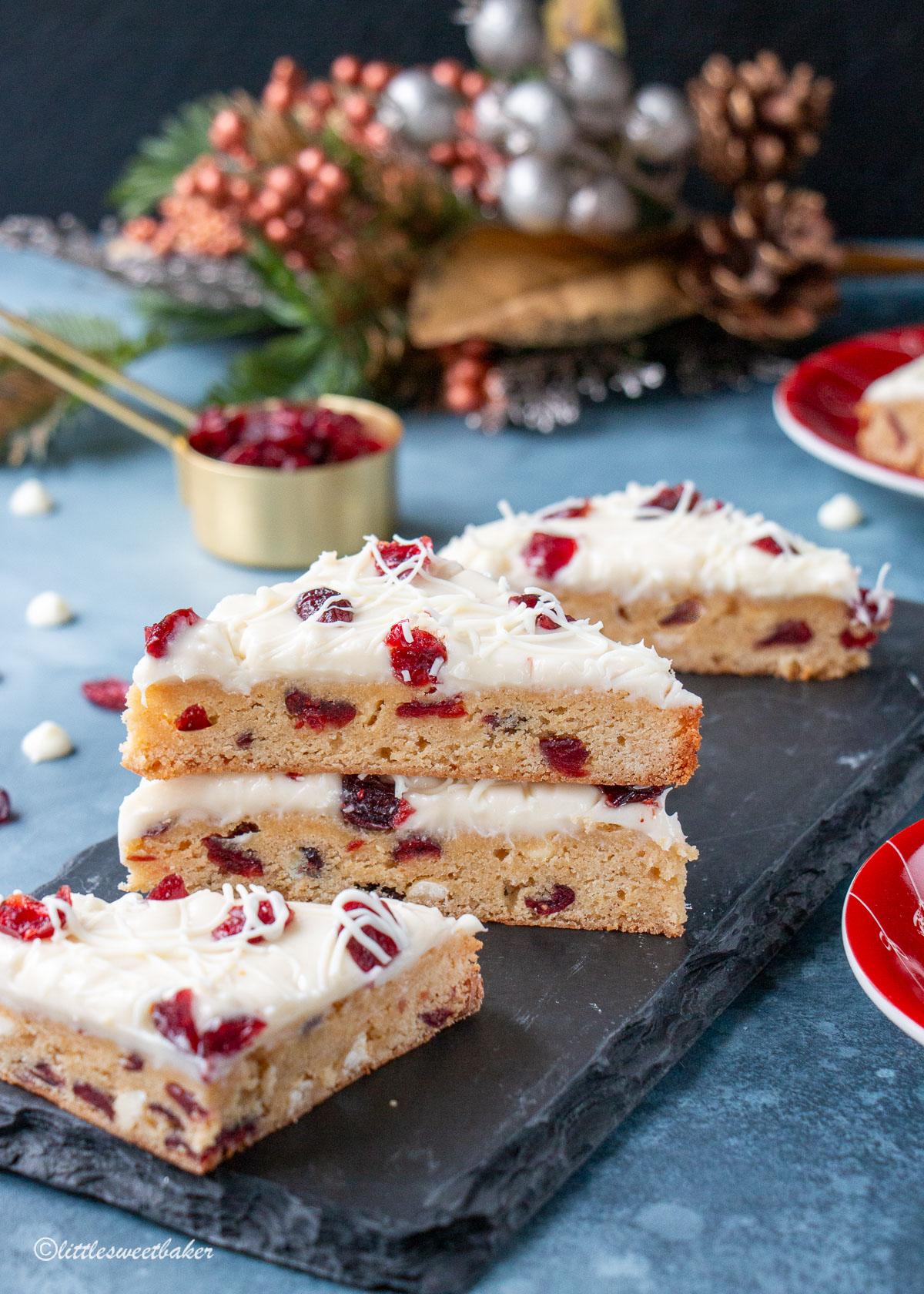Cranberry bliss bars on a black piece of slate