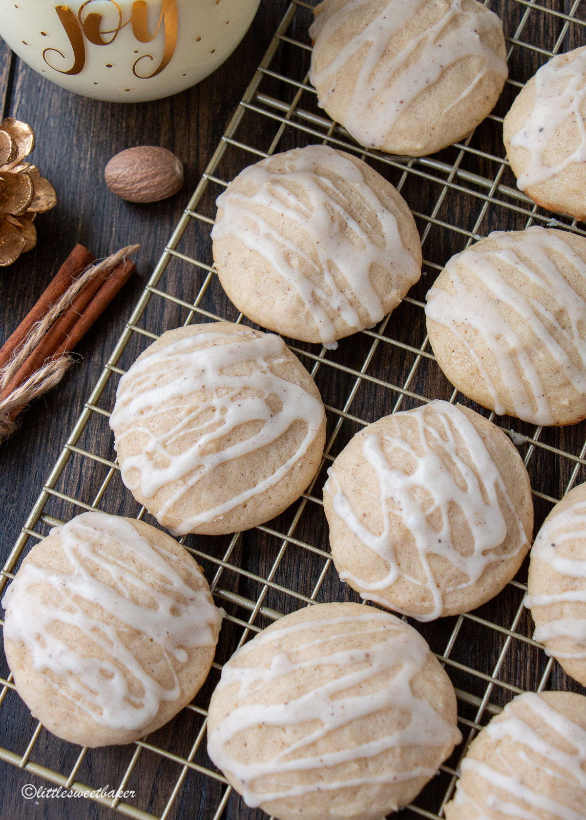 Glazed eggnog cookies on a gold cooling rack