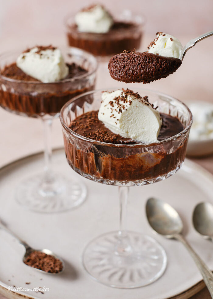 a spoonful of chocolate mousse being lifted from the glass