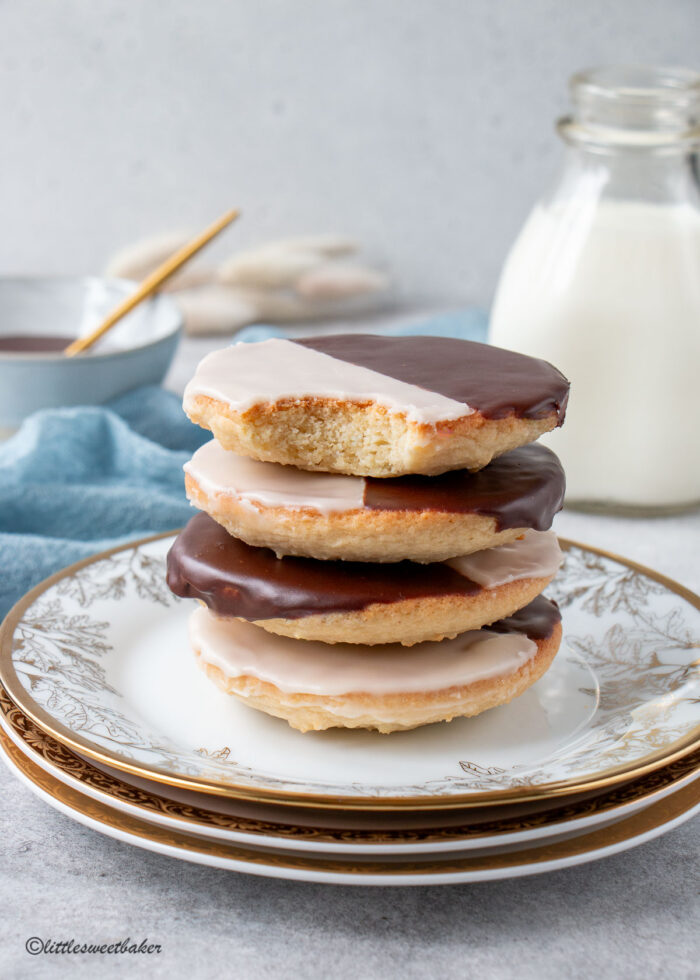 a stack of black and white cookies with a bite taken out of the top one