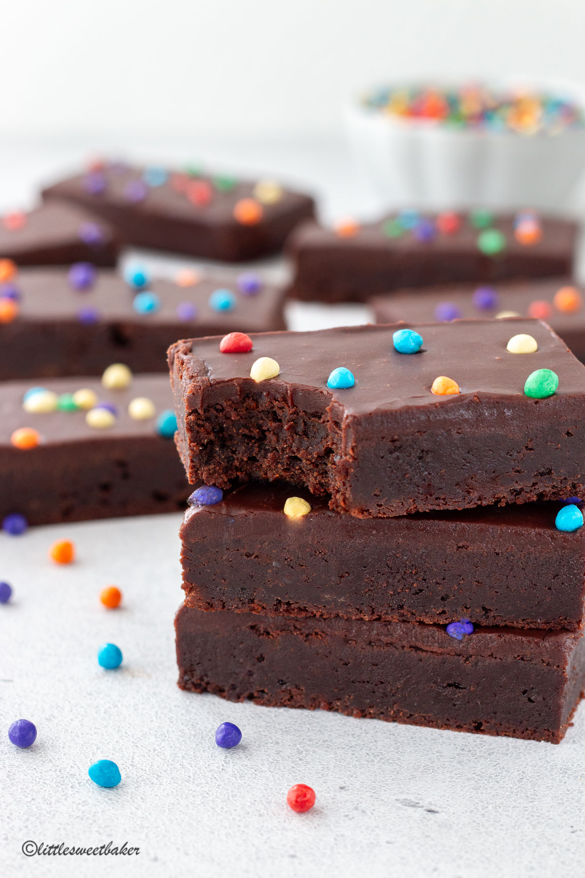 A stack of homemade cosmic brownies with a bite taken out of the top one