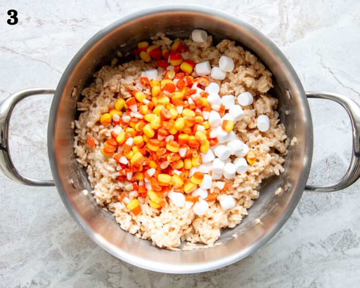 A pot of marshmallow rice krispies with chopped candy corn and mini marshmallows.