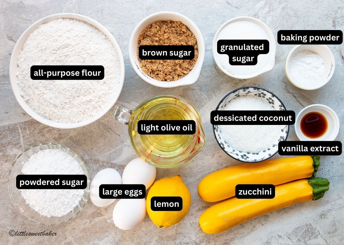 A labelled image of all the ingredients needed to make lemon zucchini cake.